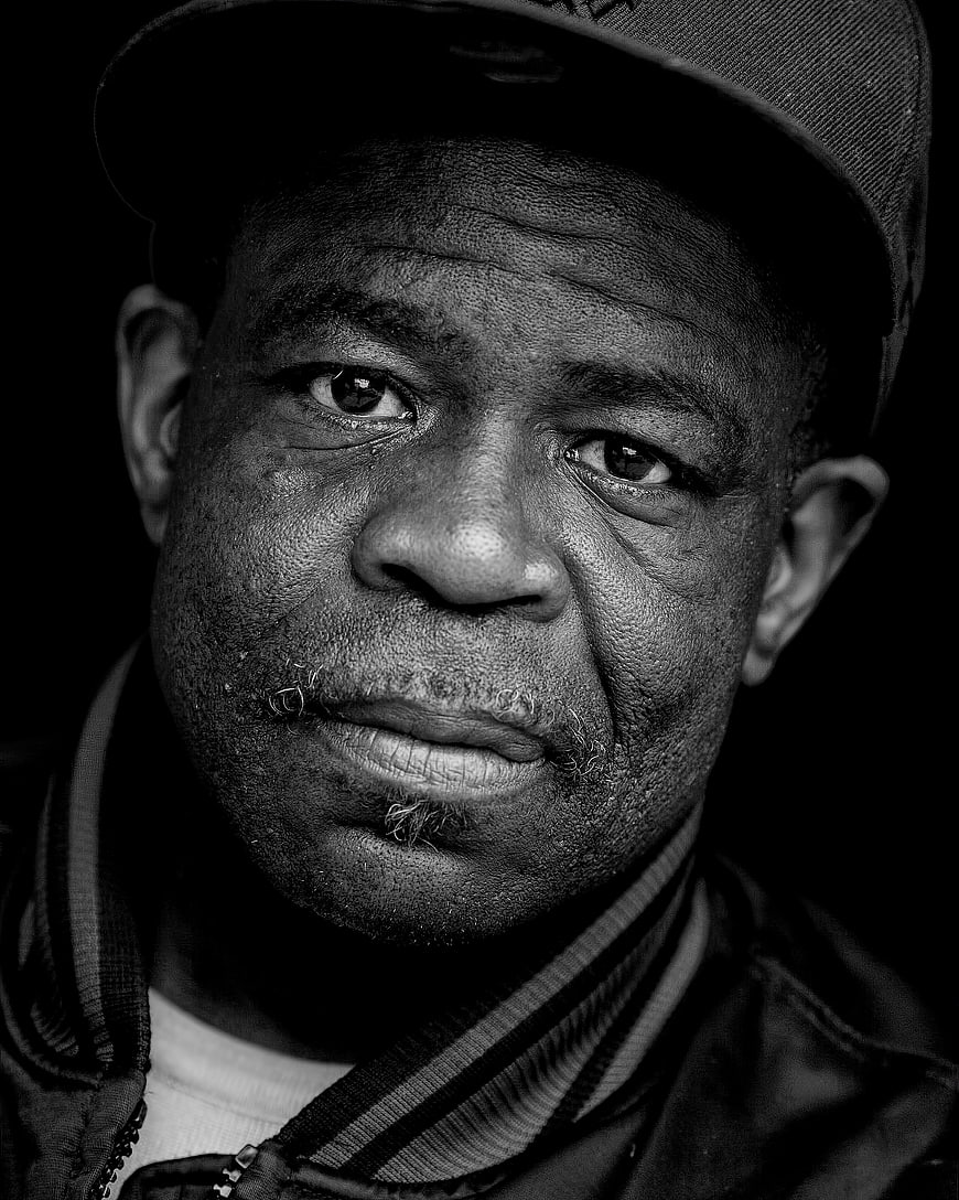 Black and white portrait of a man in a cap