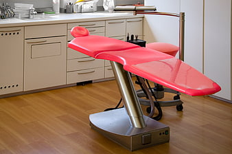 Modern Red Medical Examination Chair in Clinic