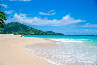 Tropical Beach with Turquoise Water and Green Hills