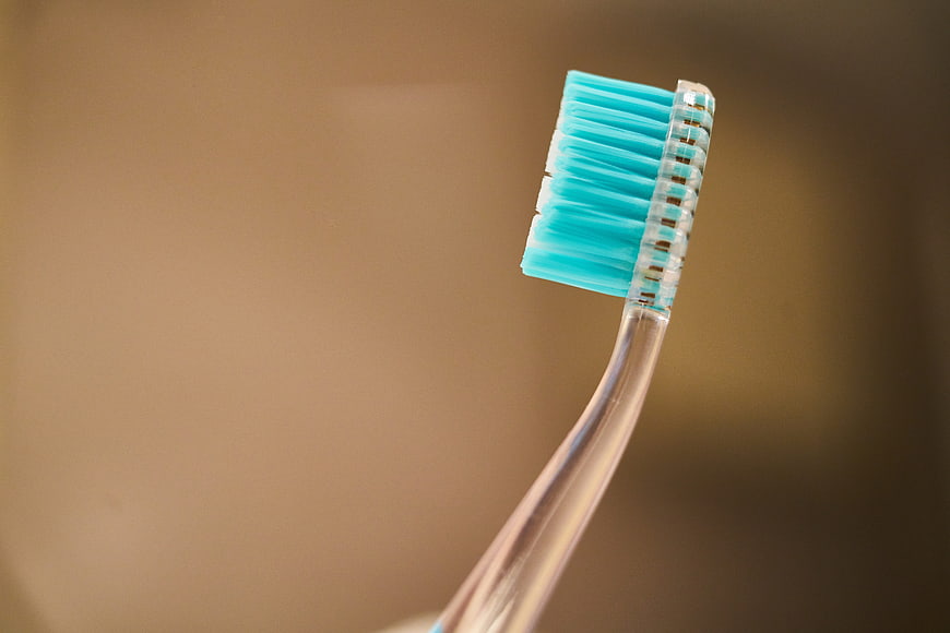 Close-up of blue toothbrush bristles on beige background