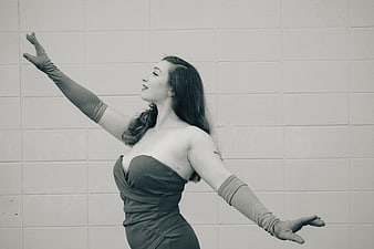 Vintage style woman in strapless dress and gloves posing