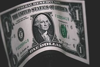 Close-up of Curved One Dollar Bill on Dark Background