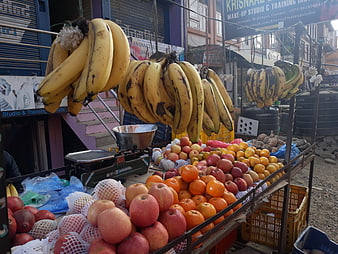 Street fruit stand with bananas, apples, and oranges in Bhaktapur