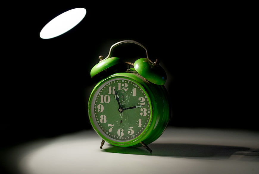 Vintage Green Alarm Clock in Spotlight