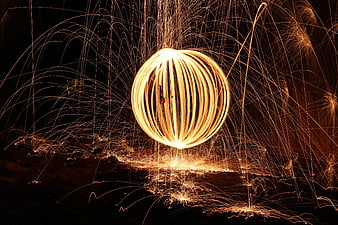Long exposure steel wool fire spinning sphere at night
