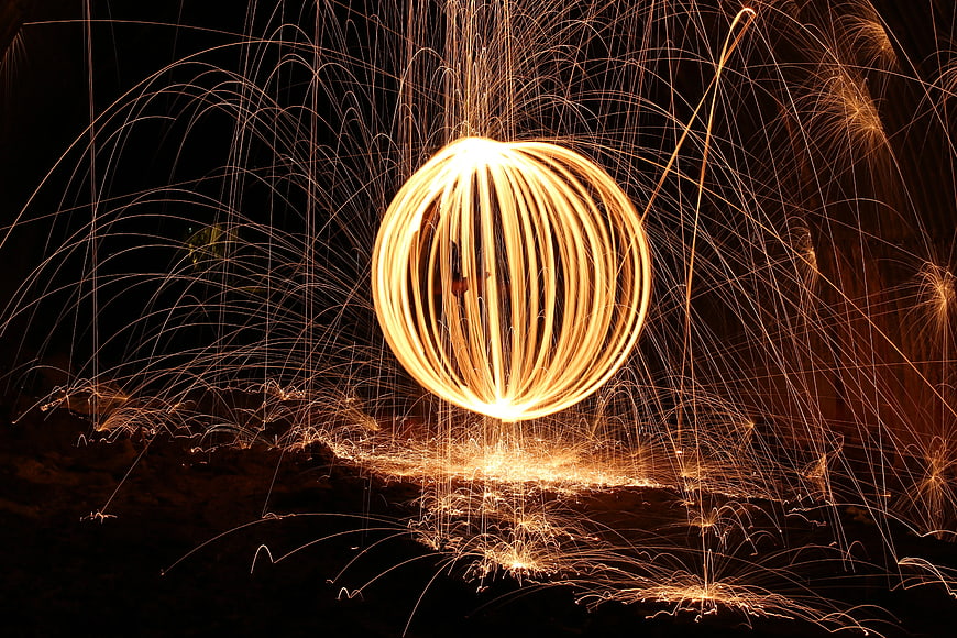 Long exposure steel wool fire spinning sphere at night