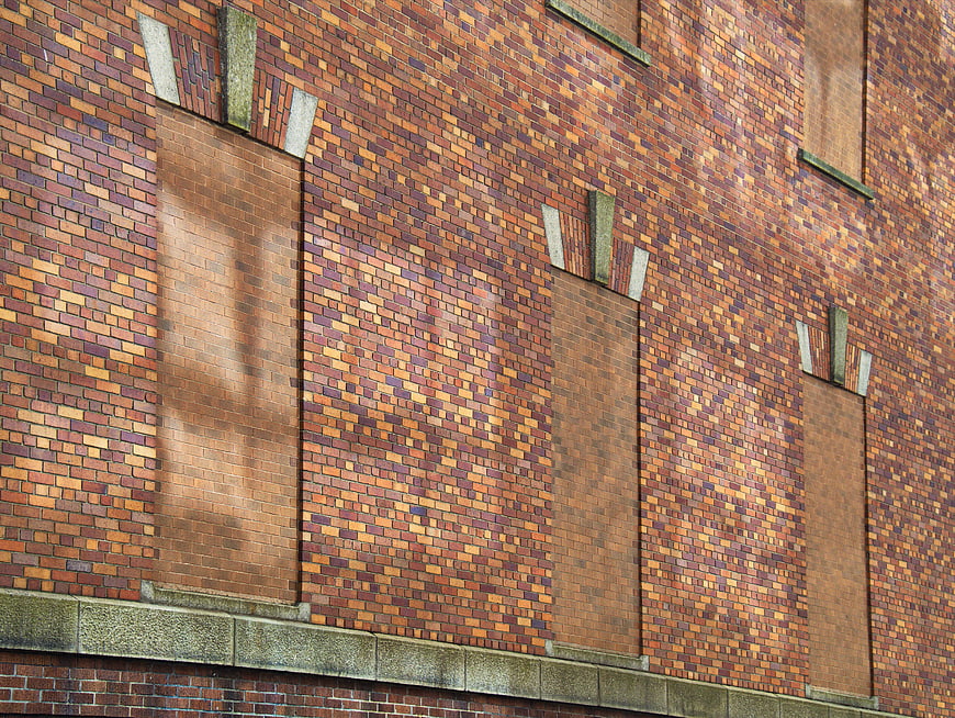 Textured Brick Wall with Filled Windows and Stone Details