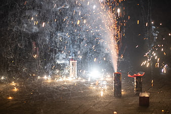 Bottle Rockets Fireworks Sparking at Night on Pavement