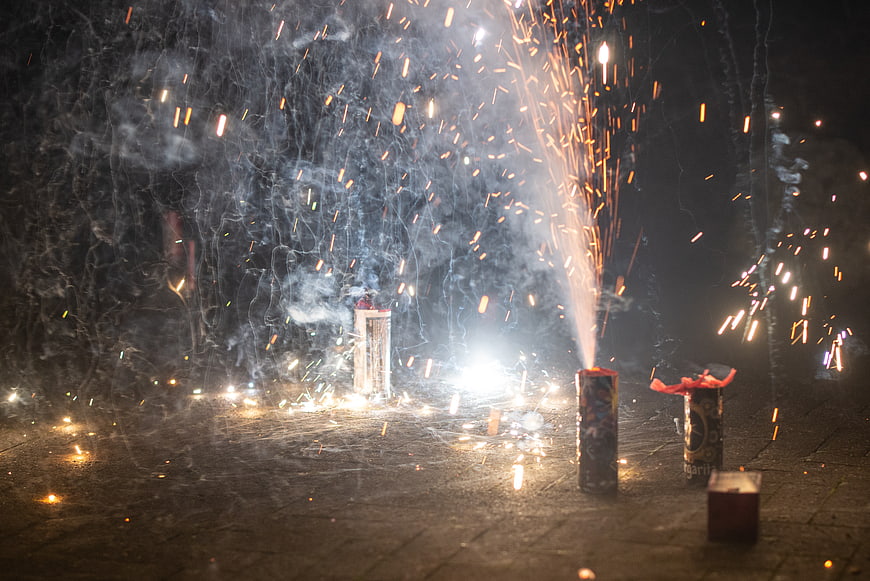 Bottle Rockets Fireworks Sparking at Night on Pavement