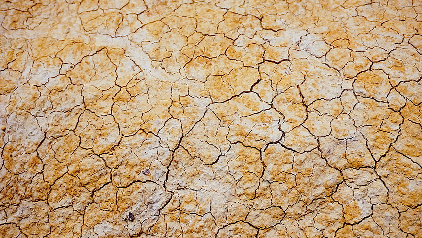 Close-up of cracked dry earth texture background