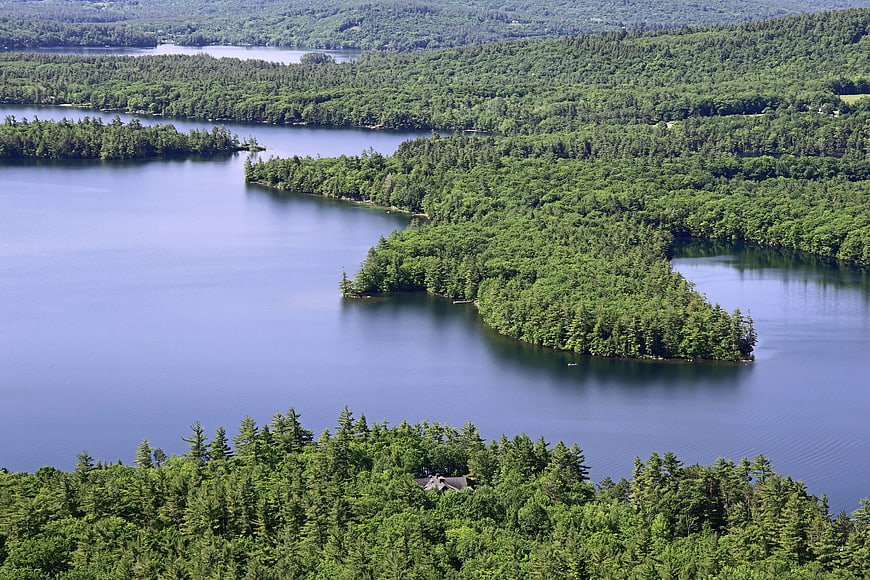 Aerial View of Forested Peninsula in Blue Lake