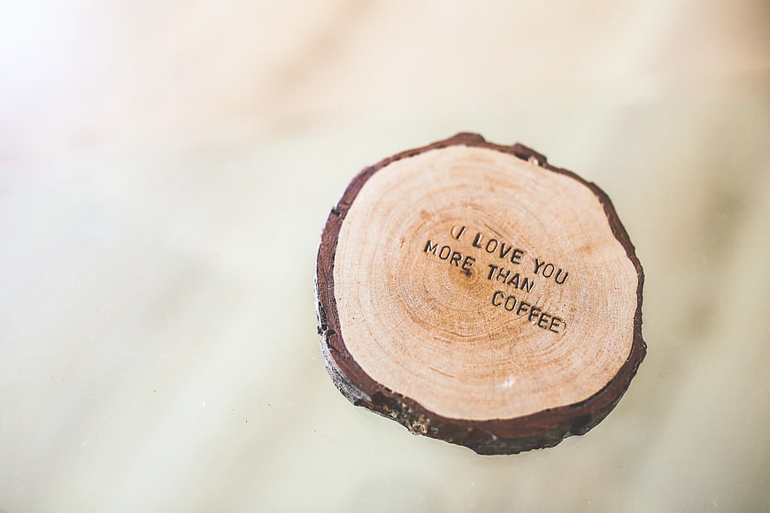 Wood slice engraved with I love you more than coffee