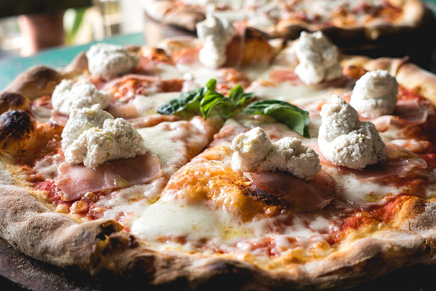 Close-up of artisanal pizza with fresh ricotta and basil