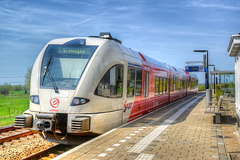 Red and silver Arriva train at a Dutch railway station platform