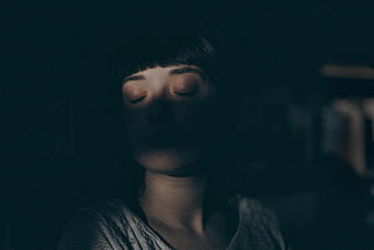 Cinematic Portrait of Woman Sleeping in Dark Room