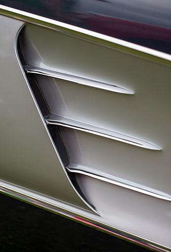 Close-up of vintage car side vent with chrome trim