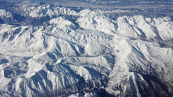 Aerial view of snow-covered mountain range in winter