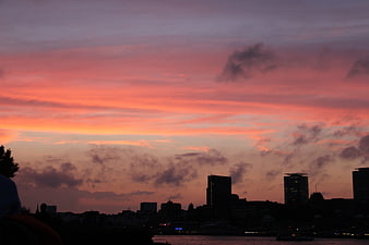 Vibrant pink and orange sunset over Hamburg city skyline silhouette
