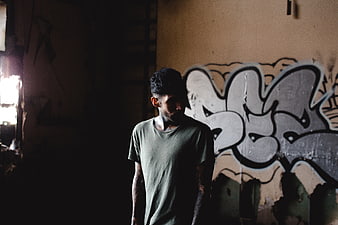 Moody Portrait of Tattooed Man in Abandoned Building