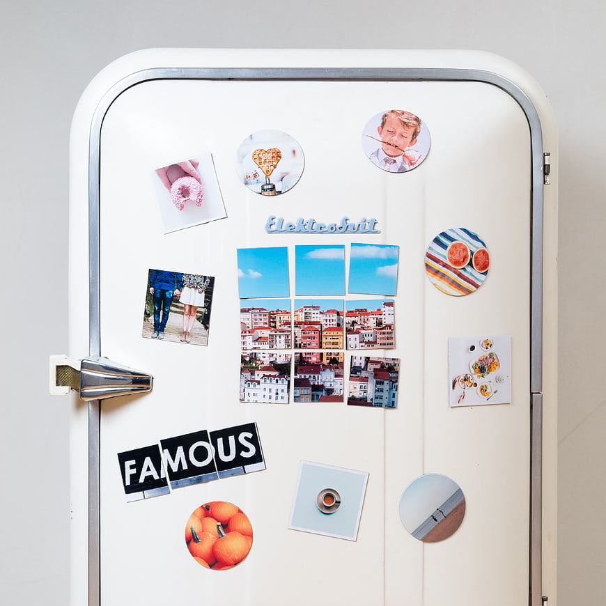 Retro white refrigerator with magnets and photos