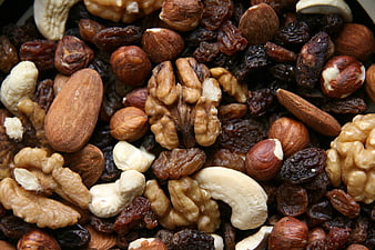 Close-up of mixed nuts and dried fruits including almonds and raisins