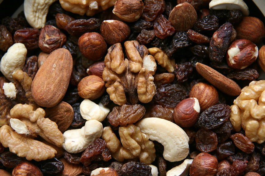 Close-up of mixed nuts and dried fruits including almonds and raisins