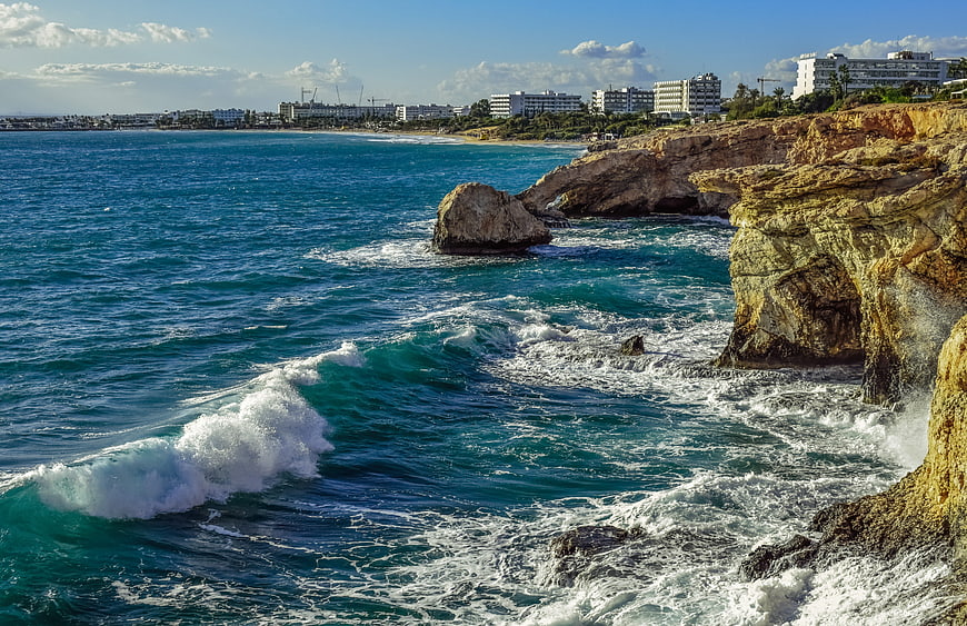 Rugged Mediterranean Coastline with Turquoise Waves and Cliffs