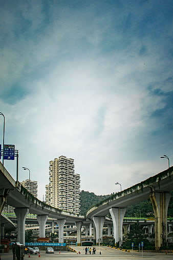 Urban overpass network with skyscrapers and blue sky
