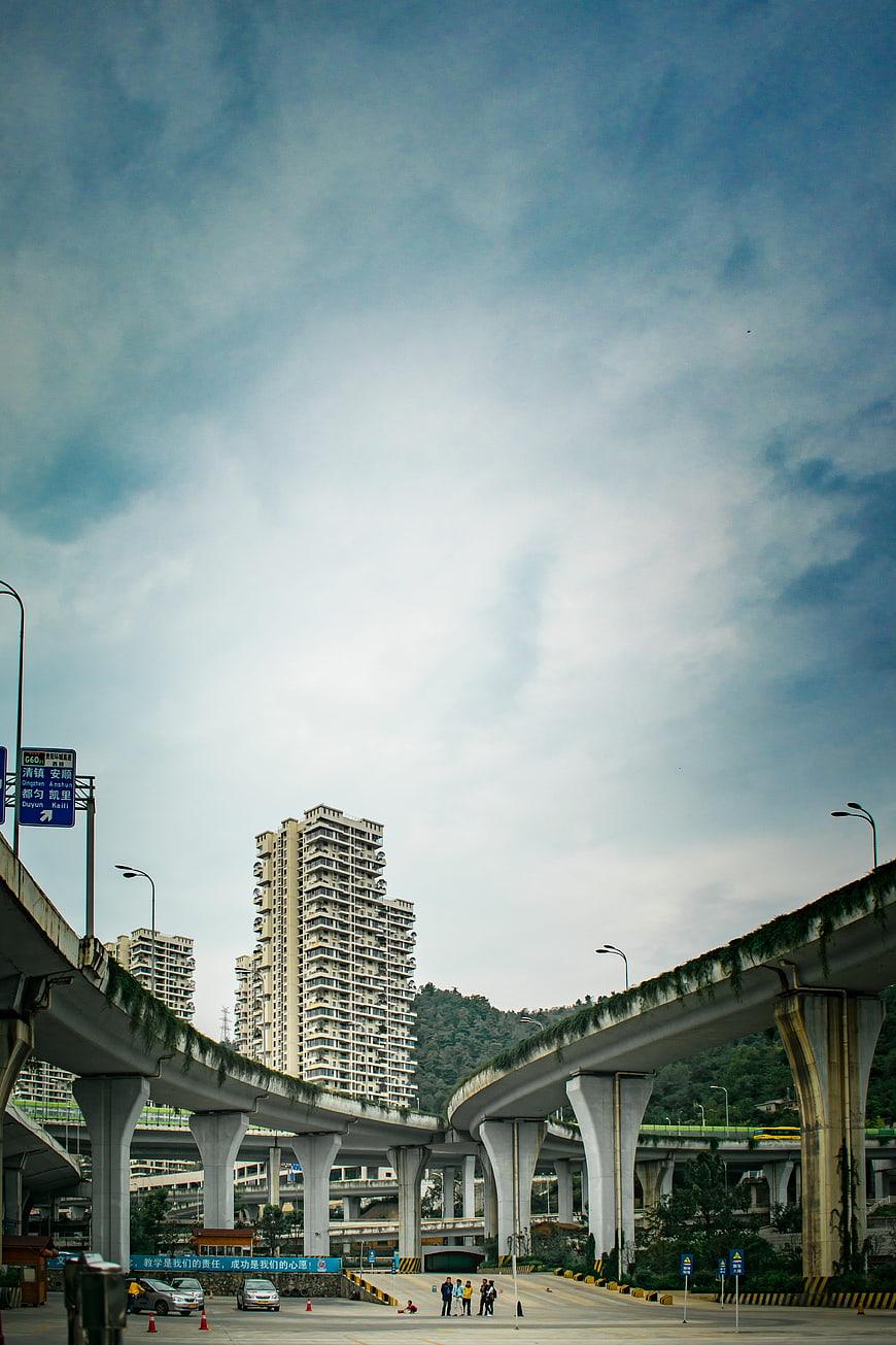 Urban overpass network with skyscrapers and blue sky