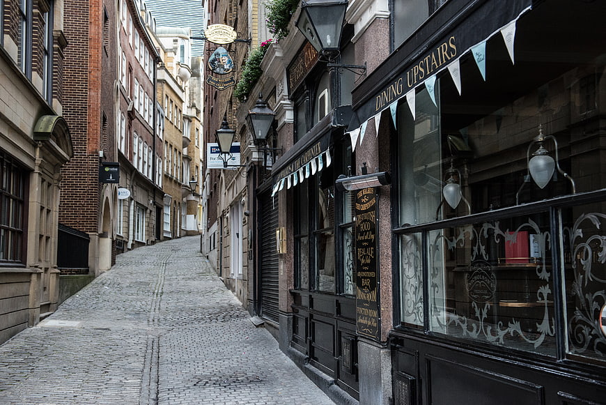 Cobblestone alleyway with traditional British pub and dining