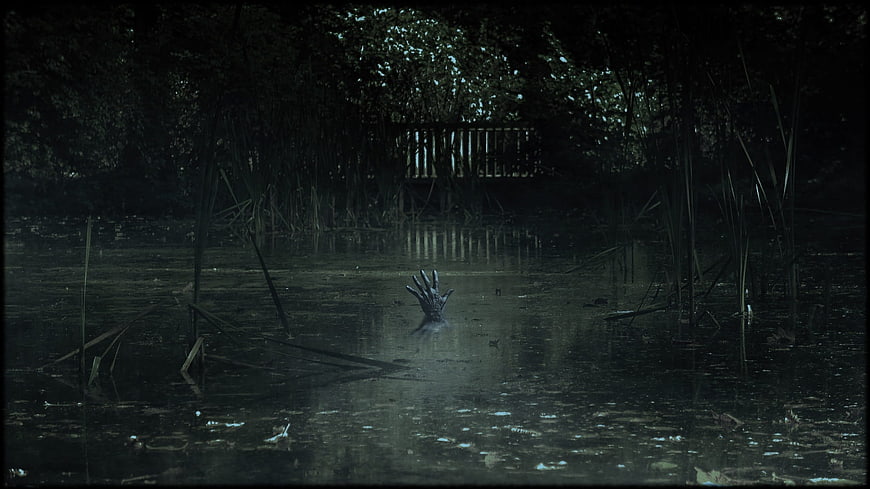 Horror Hand Emerging From Dark Swamp Water At Night