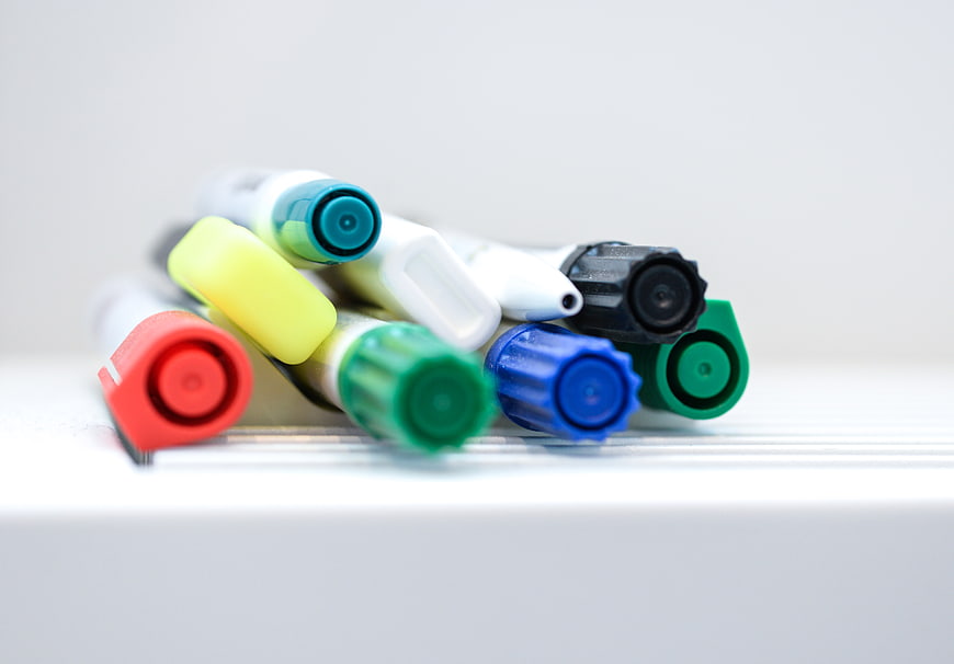 Colorful markers on whiteboard with copyspace