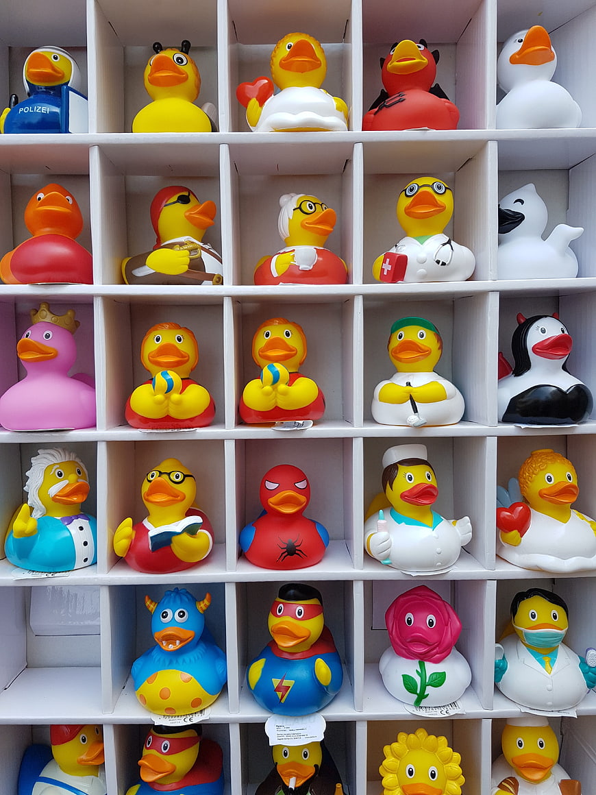 Colorful rubber duck collection on white grid shelves