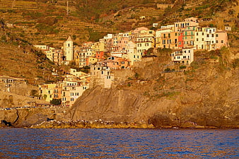 Colorful coastal village on steep cliffs overlooking the sea