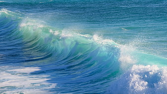 Turquoise ocean wave crashing with white sea foam