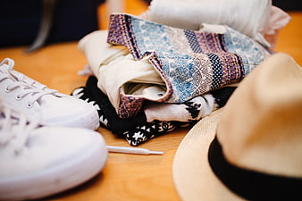 Summer travel outfit with sneakers, hat, and patterned clothes