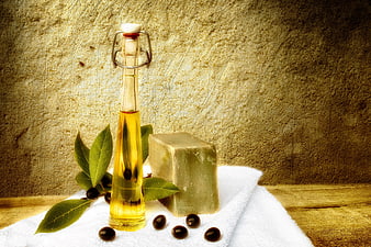 Aleppo soap bar with olive oil bottle and laurel berries