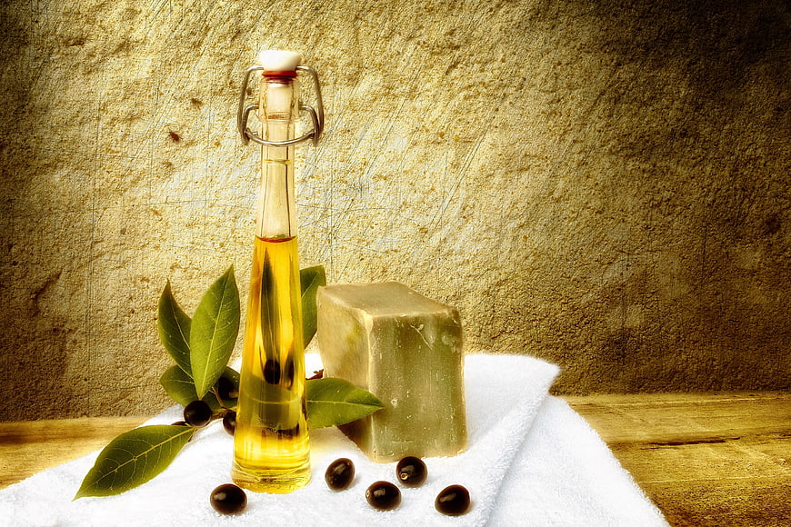Aleppo soap bar with olive oil bottle and laurel berries