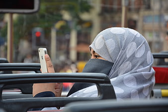 Woman in Hijab Using Smartphone in Urban Setting