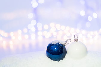 Blue and White Christmas Ornaments in Snow with Bokeh Lights