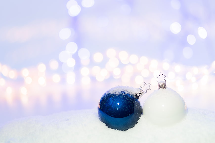 Blue and White Christmas Ornaments in Snow with Bokeh Lights