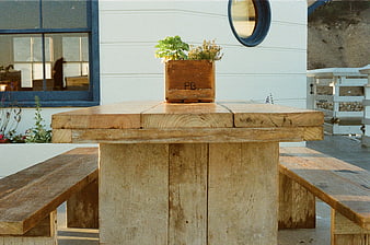 Rustic wooden picnic table with planter box outdoors