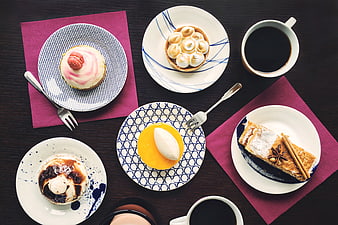 Overhead View of Assorted Desserts and Coffee on Dark Table