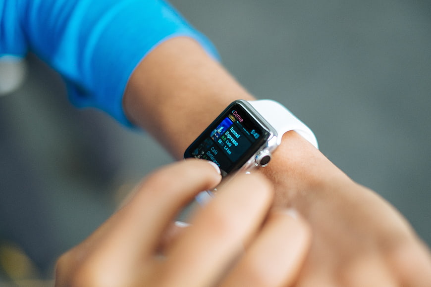 Close-up of person using smartwatch with white band