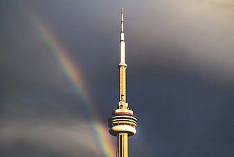 CN Tower with Rainbow Against Dramatic Cloudy Sky