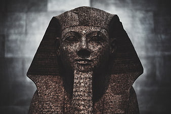 Dark moody close-up of ancient Egyptian pharaoh statue