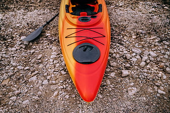 High-Angle View of Orange Kayak on Rocky Shore