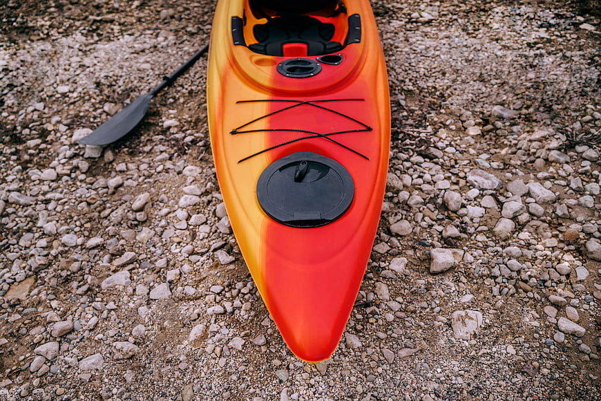 High-Angle View of Orange Kayak on Rocky Shore