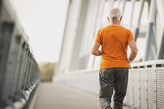 Senior Man Running on Bridge from Behind