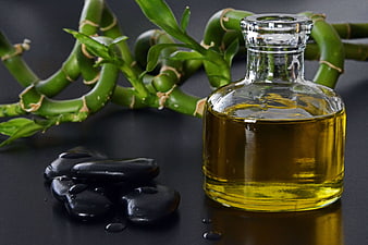 Massage oil bottle with bamboo and black stones